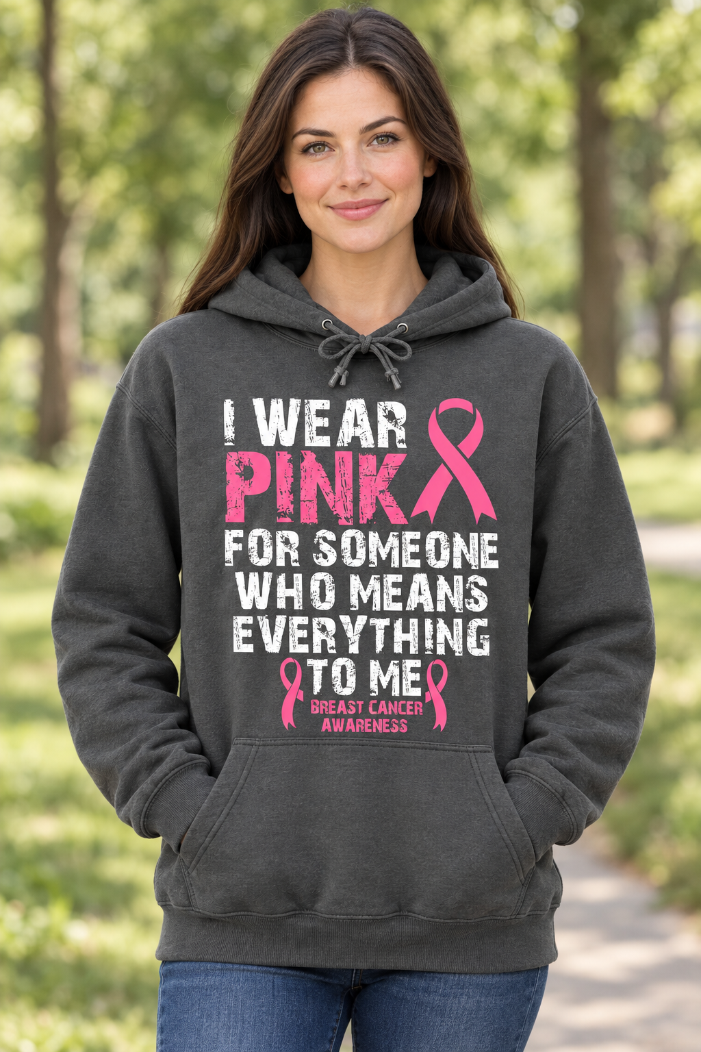 AI-generated model mockup of a woman wearing the gray Wear Pink for Someone Who Means Everything to Me hoodie with pink awareness ribbons.